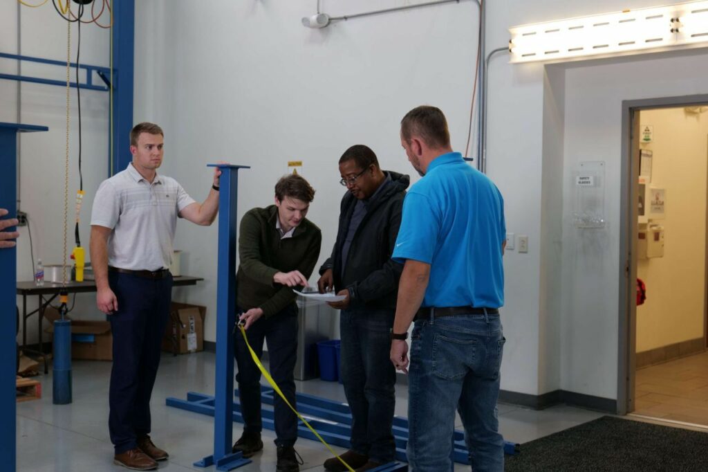 Working through the layout: measuring and levelling during crane assembly.